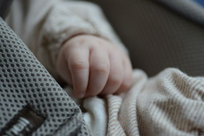 Cropped image of baby on fabric