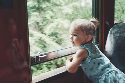 Child looking out train window