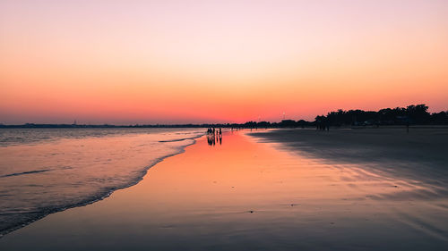 Scenic view of beach against sky during sunset