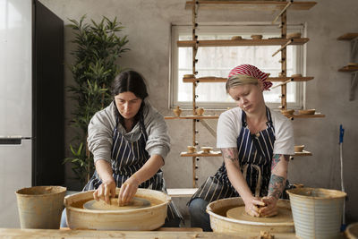 Women using potters wheels