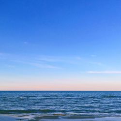 Scenic view of sea against clear blue sky