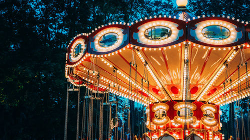 Low angle view of illuminated carousel