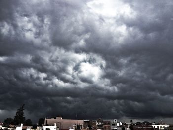 Buildings against cloudy sky