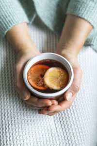 High angle view of hand holding tea cup