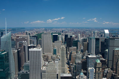 Aerial view of buildings in city against sky