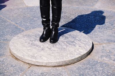 Low section of man standing on footpath