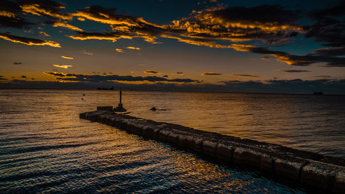 Scenic view of sea against sky at sunset
