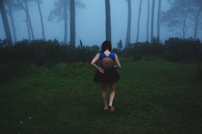 Full length of girl walking on grassy field