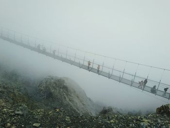 Bridge over sea in foggy weather