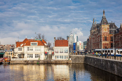 Canals, central railway station and tram at the old central district of amsterdam