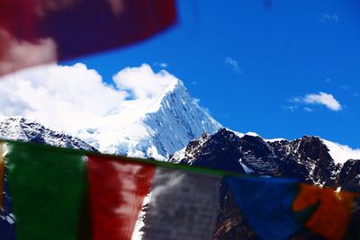 Snow covered mountains against blue sky