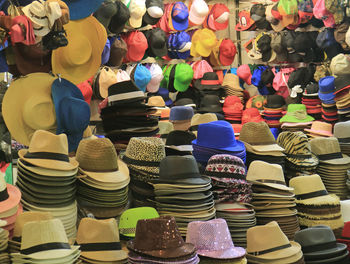 Multi colored hats for sale at market stall