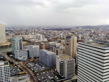 High angle view of modern buildings in city against sky