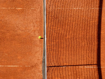 High angle view of net and ball on tennis court