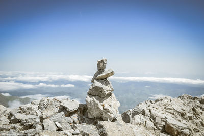 Stack of rocks against blue sky