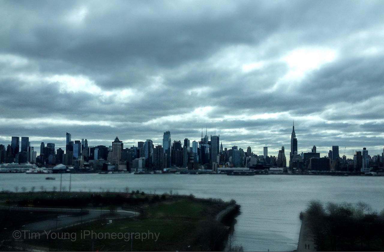 city, building exterior, skyscraper, cityscape, architecture, built structure, sky, urban skyline, water, river, tower, cloud - sky, tall - high, financial district, modern, office building, skyline, cloudy, capital cities, waterfront