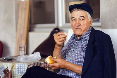 Portrait of man sitting at home