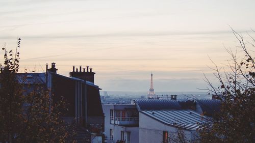 Buildings against cloudy sky