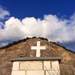 Low angle view of cross against blue sky