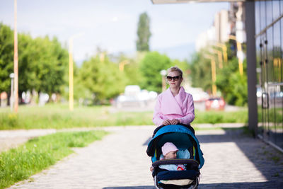 Portrait of woman with child on road