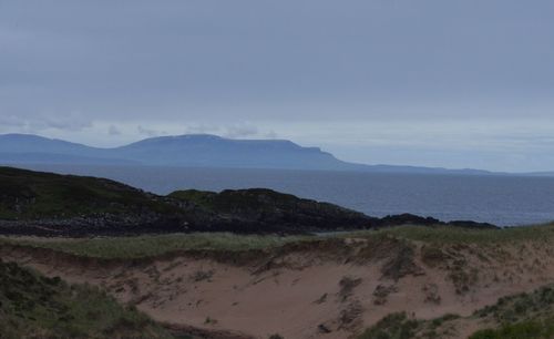 Scenic view of mountain against cloudy sky