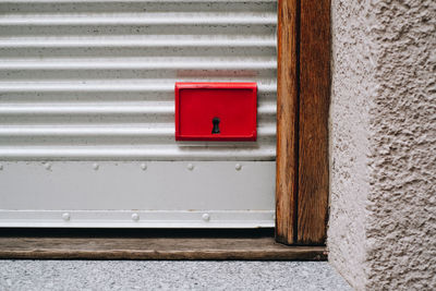 Close-up of red door on wall