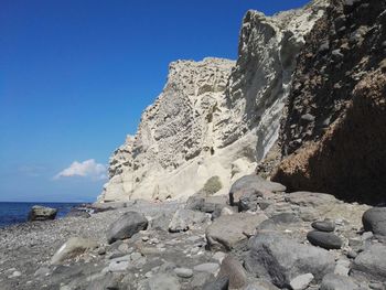 Scenic view of rocky mountains against blue sky