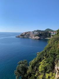 Scenic view of sea against clear blue sky