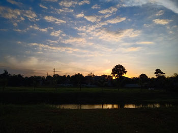 Scenic view of field against sky during sunset