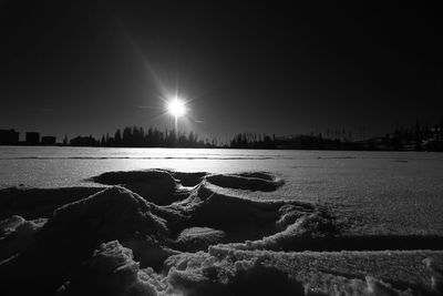 Scenic view of frozen lake against clear sky during winter