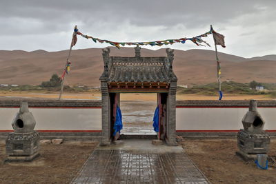 1116 buddhist prayer flags lung ta-e..facing arch-badain jaran desert temple. inner mongolia-china.