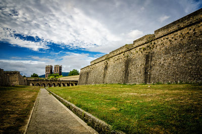 View of old building against cloudy sky