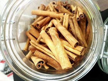 Directly above shot of cinnamon sticks in glass jar