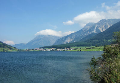 Scenic view of sea and mountains against sky