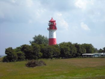 Lighthouse against cloudy sky