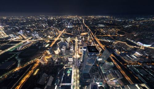 High angle view of illuminated cityscape against sky at night