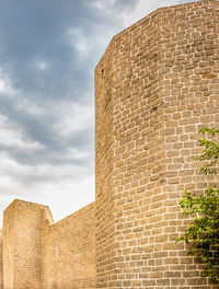 Low angle view of building against cloudy sky