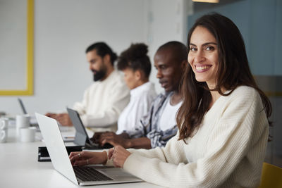 Friends using laptop at home