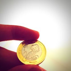 Cropped image of hand holding over white background