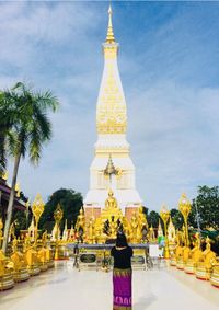 Temple by building against sky