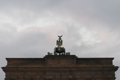 Low angle view of statue at brandenburg gate against sky