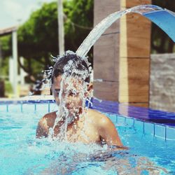 Portrait of shirtless man in swimming pool