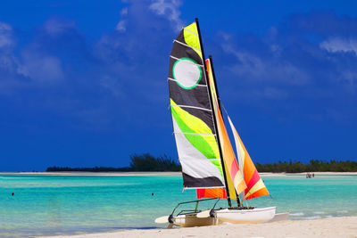 Scenic view of beach against blue sky