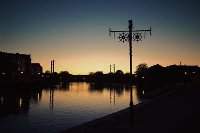 View of illuminated street lights at dusk