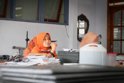 Portrait of woman working on table