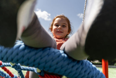 Low angle view of young woman sitting outdoors