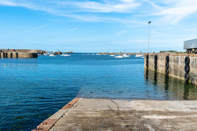 Scenic view of sea by buildings against sky