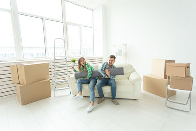 Young couple sitting on sofa at home