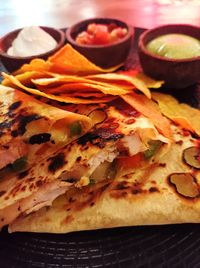 High angle view of  quesadilla grilled chicken in plate on table with red light