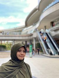 Portrait of young woman in green hijab